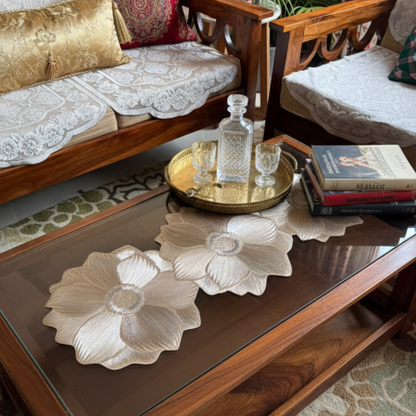 Golden floral PVC table runner placed on wooden center table in a styled living room setup