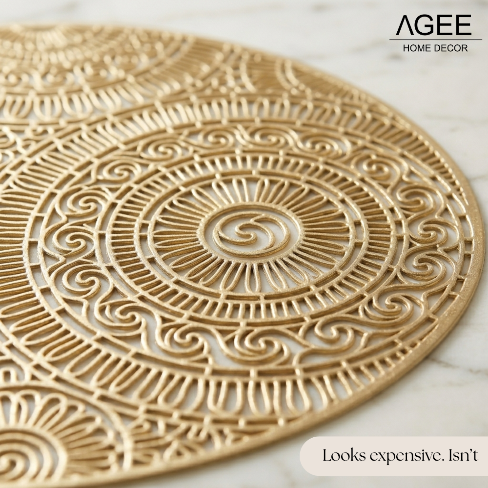 Detailed close-up of round gold mandala placemat made of heat-resistant PVC vinyl on a wooden dining table