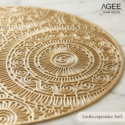 Detailed close-up of round gold mandala placemat made of heat-resistant PVC vinyl on a wooden dining table